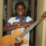 Happy Awu with his guitar